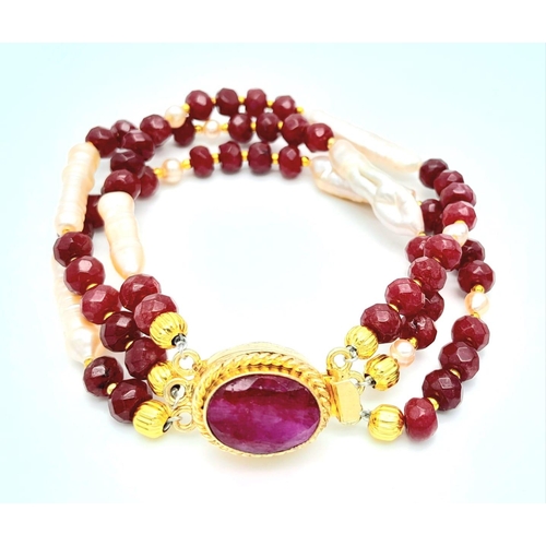 228 - A very glamorous three row necklace and bracelet set with multi-faceted rubies and large, pink, unus... 