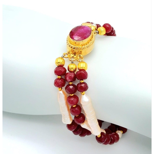 228 - A very glamorous three row necklace and bracelet set with multi-faceted rubies and large, pink, unus... 