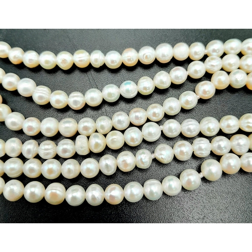 270 - A fabulous six strand natural pearl bracelet with a large bow shaped clasp adorned with dozens of cu... 