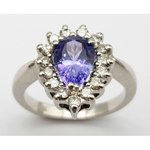 109 - An 18 K white gold ring with a pear cut tanzanite (1.71 carats) surrounded by a halo of diamonds, ri... 