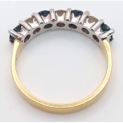 227 - An 18 K yellow gold ring with a band of alternating round cut diamonds and blue sapphires. Size: K, ... 