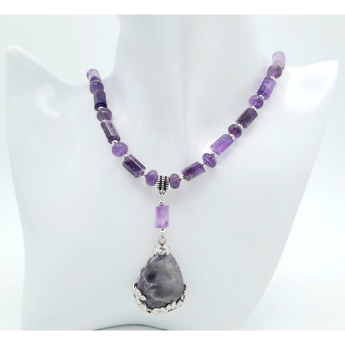 235 - An original Brazilian AMETHYST necklace and earrings set, with round and cylindrical alternating bea... 