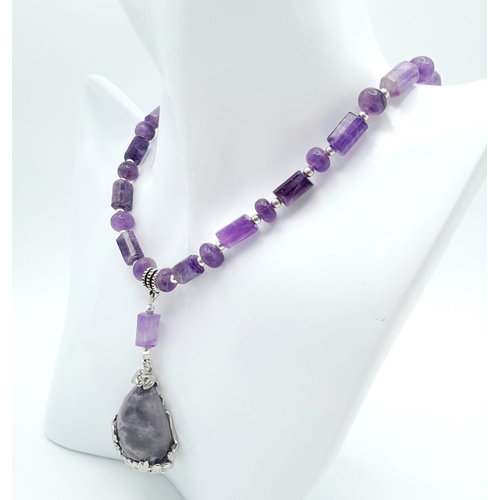 235 - An original Brazilian AMETHYST necklace and earrings set, with round and cylindrical alternating bea... 