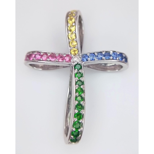 247 - A highly unusual 14 K white gold cross studded with emeralds, rubies citrine and sapphires. Dimensio... 