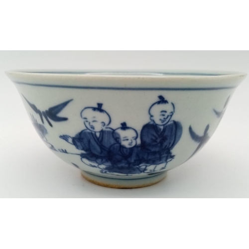 256 - A Chinese blue and white hand painted bowl decorated with children playing with birds. White porcela... 