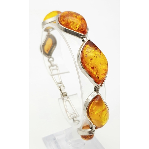 284 - An amber bracelet with matching earrings set in a presentation box, bracelet length: 20 cm, earrings... 