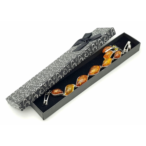 284 - An amber bracelet with matching earrings set in a presentation box, bracelet length: 20 cm, earrings... 