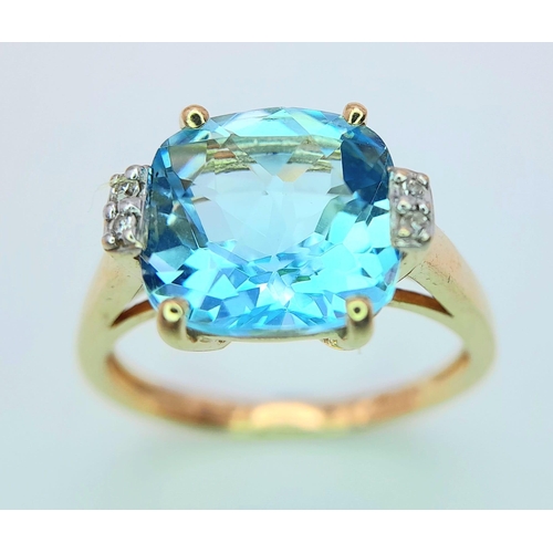 311 - A very attractive 14 K yellow gold ring with a large, cushion cut aquamarine and a pair of diamonds ... 