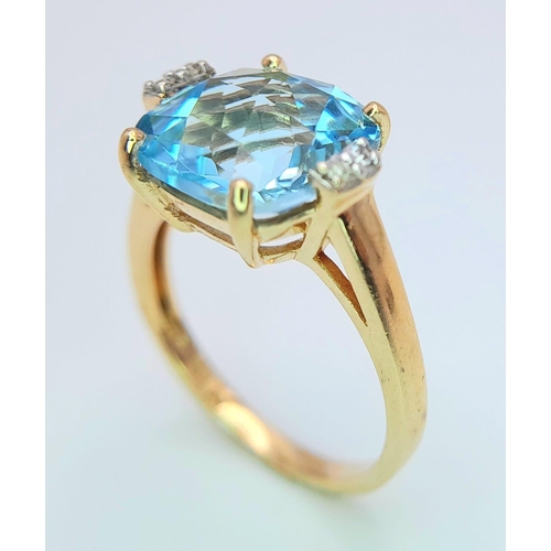 311 - A very attractive 14 K yellow gold ring with a large, cushion cut aquamarine and a pair of diamonds ... 