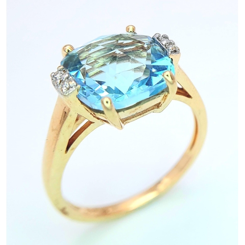 311 - A very attractive 14 K yellow gold ring with a large, cushion cut aquamarine and a pair of diamonds ... 