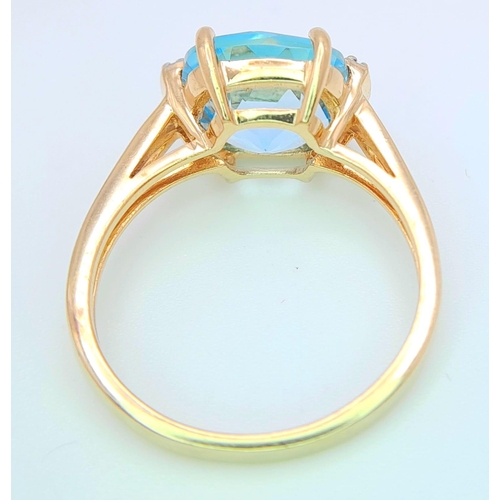 311 - A very attractive 14 K yellow gold ring with a large, cushion cut aquamarine and a pair of diamonds ... 