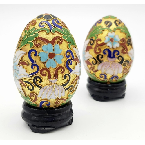 319 - Two vintage and very ornamental Chinese cloisonne eggs standing on custom-made wooden bases. Height:... 