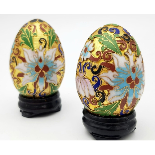 319 - Two vintage and very ornamental Chinese cloisonne eggs standing on custom-made wooden bases. Height:... 