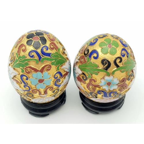 319 - Two vintage and very ornamental Chinese cloisonne eggs standing on custom-made wooden bases. Height:... 