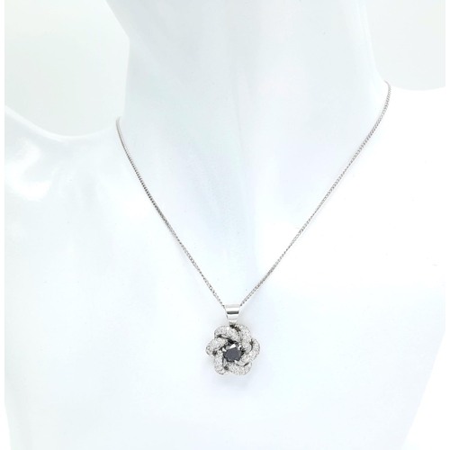 386 - An 18K White Gold Necklace with a Black and White Diamond Pendant. Central black diamond with white ... 