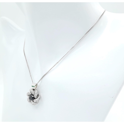 386 - An 18K White Gold Necklace with a Black and White Diamond Pendant. Central black diamond with white ... 