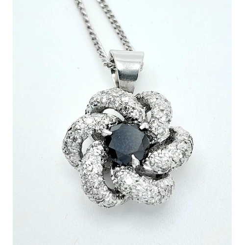 386 - An 18K White Gold Necklace with a Black and White Diamond Pendant. Central black diamond with white ... 