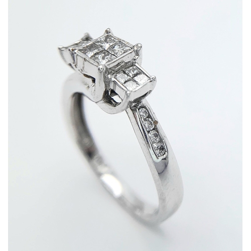 451 - A 10 K white gold diamond ring with a cross over, step design. Size: N, weight: 3.2 g. Good quality ... 