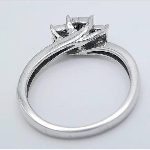 451 - A 10 K white gold diamond ring with a cross over, step design. Size: N, weight: 3.2 g. Good quality ... 