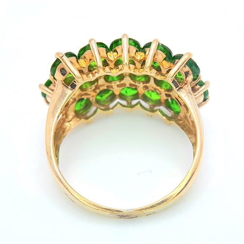 472 - A 9 K yellow gold ring with a cluster of round cut peridots arranged over three rows. Size: L, weigh... 