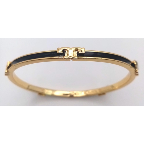 486 - A gold plated, TROY BURCH design, black enamelled bangle. Clasp not tight. Inner dimensions: 59 x 50... 