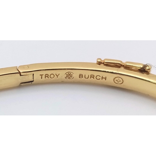 486 - A gold plated, TROY BURCH design, black enamelled bangle. Clasp not tight. Inner dimensions: 59 x 50... 