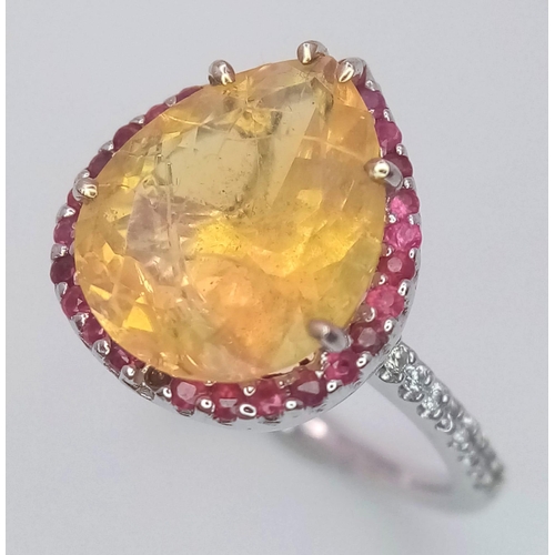 158 - An 18 K white gold ring with a large, pear cut, fire opal exhibiting orange and green hues, surround... 