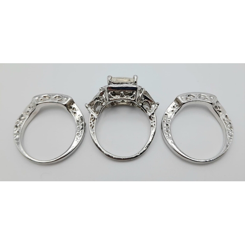 340 - A stanning trilogy of dress rings (symbolising engagement, wedding and eternity) loaded with cubic z... 