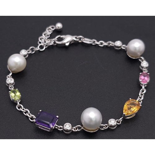 46 - An 18 K white gold chain bracelet with a variety of gemstones (peridot, amethyst, citrine, etc) and ... 