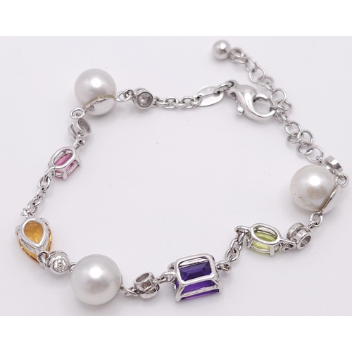 46 - An 18 K white gold chain bracelet with a variety of gemstones (peridot, amethyst, citrine, etc) and ... 