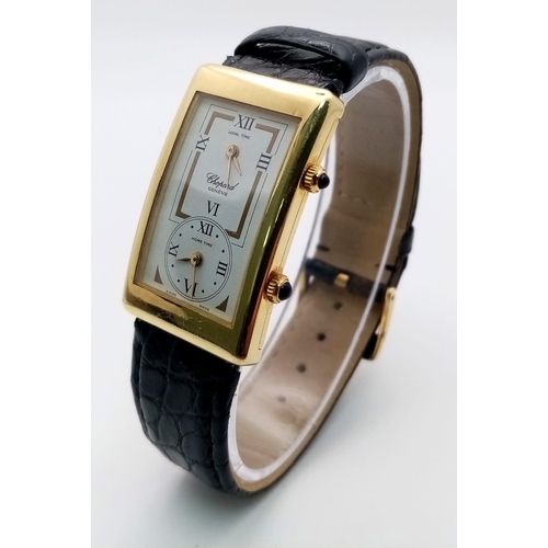 102 - A Chopard 18K Gold Home Time (Dual Time) Gents Watch. Black leather strap. 18K gold rectangular case... 