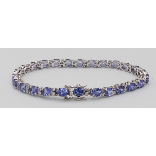 213 - A spectacular 18 K white gold bracelet with oval cut tanzanite gems and round cut diamonds. Length: ... 