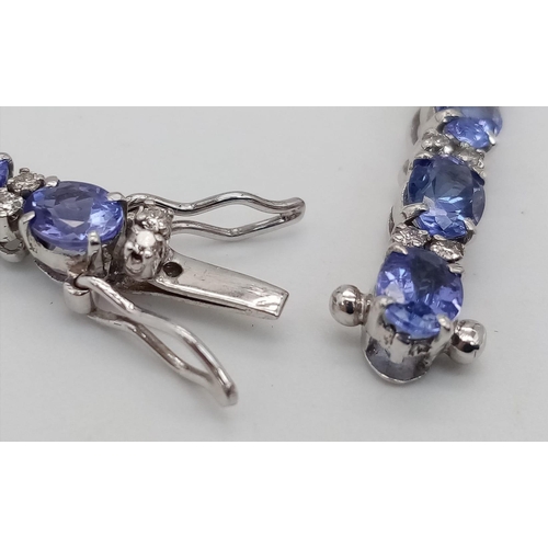 213 - A spectacular 18 K white gold bracelet with oval cut tanzanite gems and round cut diamonds. Length: ... 