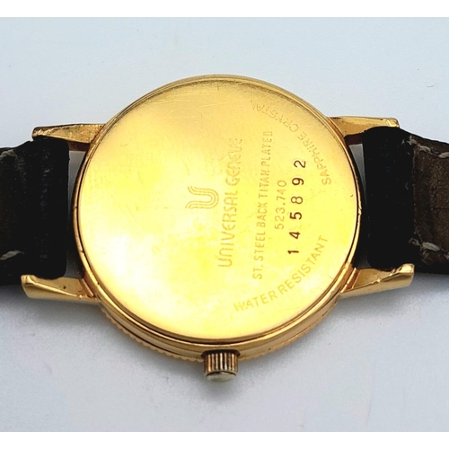 354 - A Gold Plated Universal Quartz Ladies Watch. Black leather strap. Gold plated case - 23mm. White dia... 