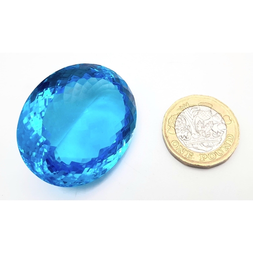 361 - A large (162.81 carats), oval cut natural topaz, with vivid sky blue uniform colouration, excellent ... 