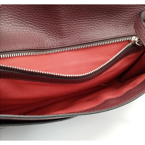 438 - A Lance Burgundy Leather Hand/Shoulder Flap Bag. Textured leather exterior. Soft red textile interio... 