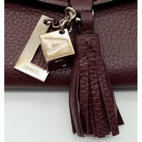 438 - A Lance Burgundy Leather Hand/Shoulder Flap Bag. Textured leather exterior. Soft red textile interio... 