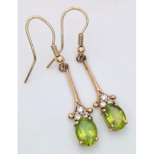 603 - A 9K Yellow Gold, Peridot Drop Earring and Pendant Set. Both decorated with seed pearls. Pendant - 4... 