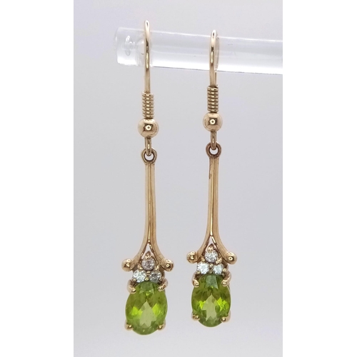 603 - A 9K Yellow Gold, Peridot Drop Earring and Pendant Set. Both decorated with seed pearls. Pendant - 4... 