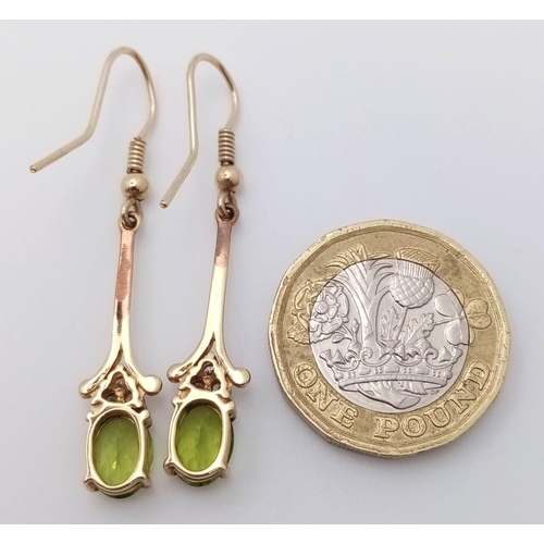 603 - A 9K Yellow Gold, Peridot Drop Earring and Pendant Set. Both decorated with seed pearls. Pendant - 4... 