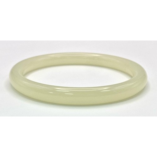 634 - A Pale Green Thin Jade Bangle. 8mm width. 6cm inner diameter.