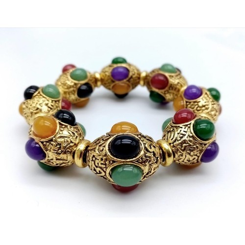 848 - A Gilded Tibetan Style Bracelet with Multi-Colour Jade Cabochon Decoration. Gilded spacers. Expandab... 