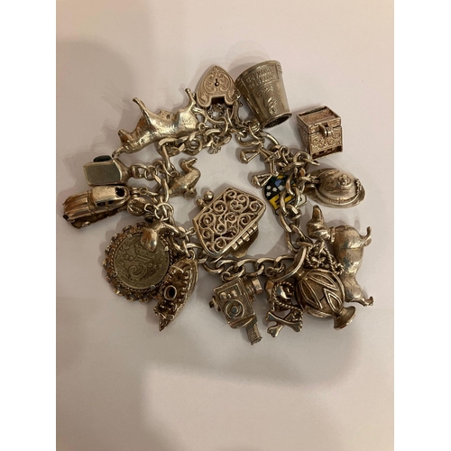 182 - Vintage SILVER CHARM BRACELET Full of unusual and interesting charms,to include an opening SILVER fi... 