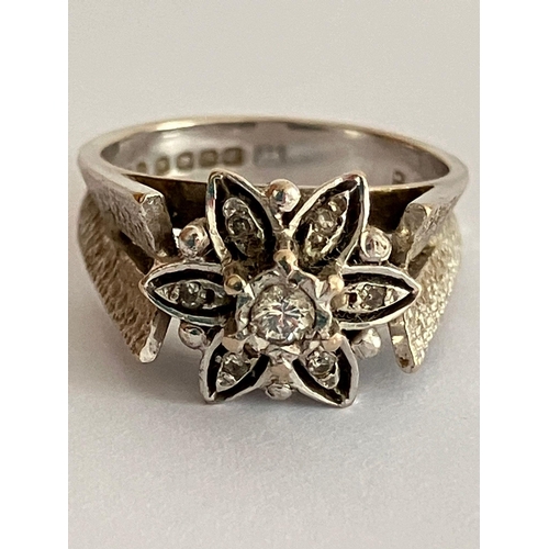 91 - Impressive 18 carat WHITE GOLD and DIAMOND RING. Having seven DIAMONDS mounted to top in floral form... 