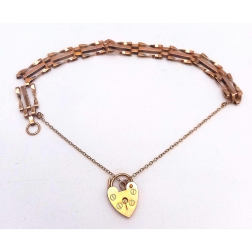 164 - A 9K GOLD GATE BRACELET WITH HEART PADLOCK AND SAFETY CHAIN .   7.5gms