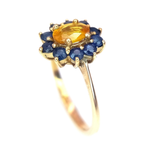 170 - A 9K GOLD RING HAVING A CENTRAL CITRINE SURROUNDED BY A HALO OF SAPPHIRES .   2.2gms   size N