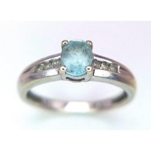 178 - A 9K WHITE GOLD AQUAMARINE AND DIAMOND RING .  2.1gms   size I