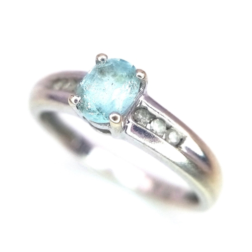 178 - A 9K WHITE GOLD AQUAMARINE AND DIAMOND RING .  2.1gms   size I