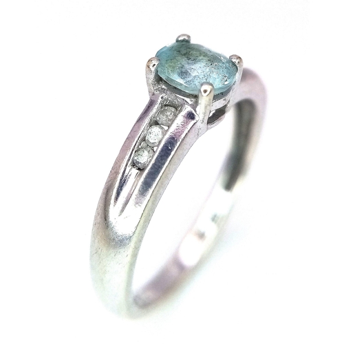 178 - A 9K WHITE GOLD AQUAMARINE AND DIAMOND RING .  2.1gms   size I