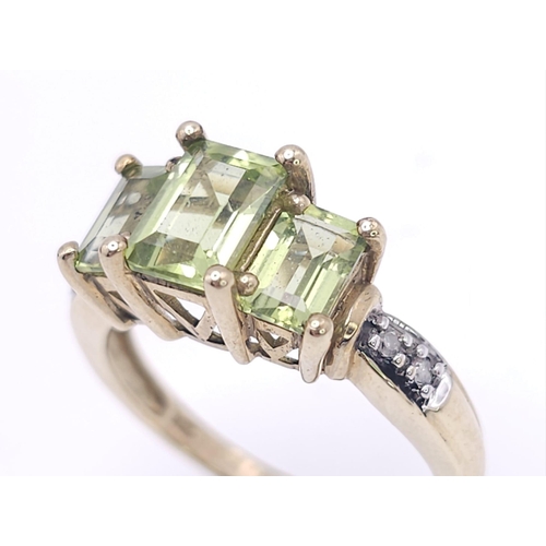 185 - A 9K GOLD PERIDOT AND DIAMOND RING .  3.1gms   size N